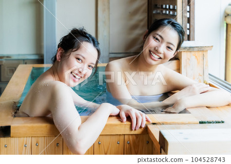 Young women relaxing in a cypress bath Young women relaxing in a cypress bath 104528743