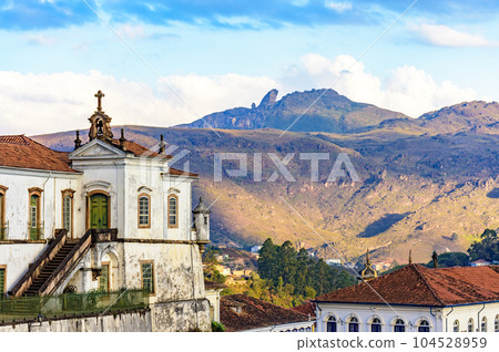 Baroque church and mountains in the city of Ouro Preto 104528959