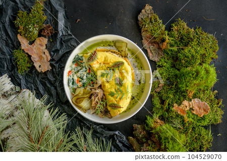 Omelette with cheese, mushrooms and herbs on a white plate Omelette with cheese, mushrooms and herbs on a white plate 104529070