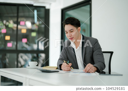 businessman or accountant working on calculator and laptop computer to calculate business data during using accountancy document at office businessman or accountant working on calculator and laptop computer to calculate business data during using accountancy document at office 104529181