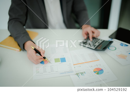 Young asian male work with financial papers at home count on calculator before paying taxes receipts online, planning budget glad to find chance for economy saving money, audit concepts 104529192