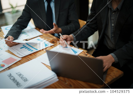 Asian business advisor meeting to analyze and discuss the situation on the financial report in the meeting room.Investment Consultant, Financial , teamwork ,brainstorming ,startup and accounting. 104529375