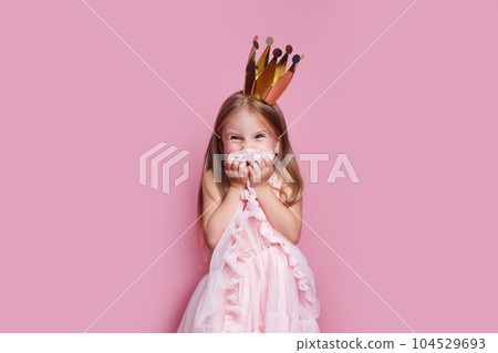 naughty little girl in a fancy dress and a crown did something bad 104529693