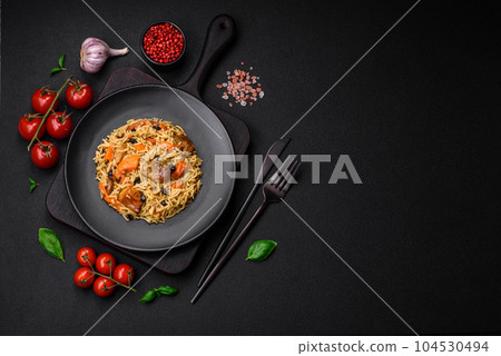 Delicious fresh pilaf with rice, carrots, meat, onions, spices and berries 104530494