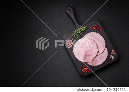 Delicious fresh ham cut into round slices with salt, spices and herbs Delicious fresh ham cut into round slices with salt, spices and herbs 104530511