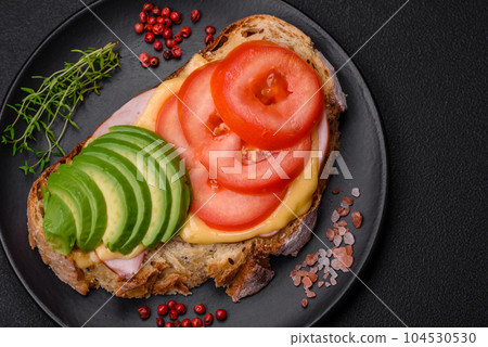 Delicious nutritious grilled toast with ham, cheese, tomatoes and avocado Delicious nutritious grilled toast with ham, cheese, tomatoes and avocado 104530530