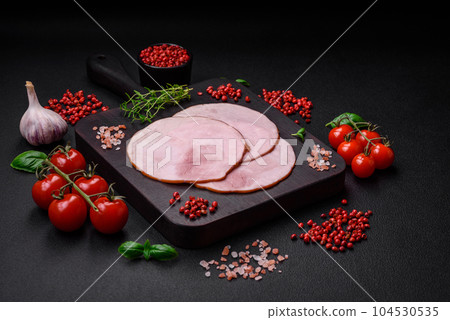 Delicious fresh ham cut into round slices with salt, spices and herbs Delicious fresh ham cut into round slices with salt, spices and herbs 104530535