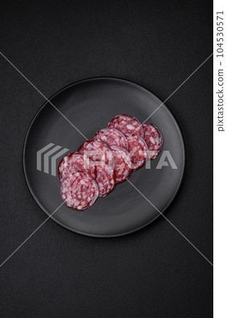 Delicious smoked sausage with bacon, salt, spices and herbs Delicious smoked sausage with bacon, salt, spices and herbs 104530571