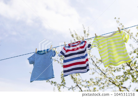 Clean clothes on rope outdoors on laundry day. Clean clothes on rope outdoors on laundry day. 104531158