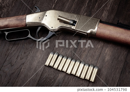 Old west guns. Lever action repeating rifles with ammunition 104531798