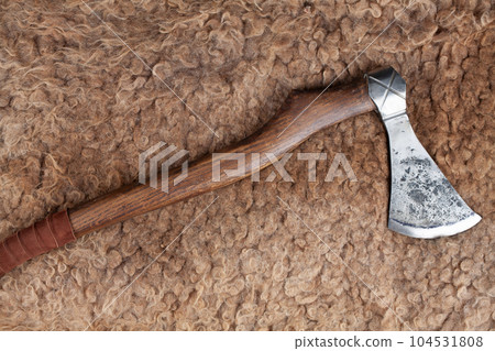 Viking battle axe on sheep fur 104531808