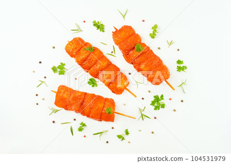 Chicken breast Fillets.Fresh raw marinated chicken fillet skewers with fresh herbs on a white background.Marinated Fresh.Closeup of chicken meat.Procurement for designers.Food concept.Top view. 104531979