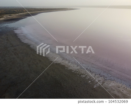 a serene lake with a muddy shore, surrounded by a tranquil atmosphere a serene lake with a muddy shore, surrounded by a tranquil atmosphere 104532069