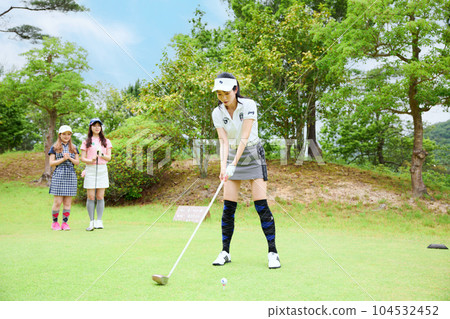 Women playing golf Women playing golf 104532452