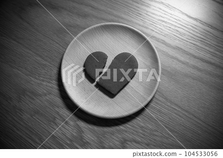 Broken heart cookie on a wooden plate Broken heart Heartbreak Monochrome 104533056