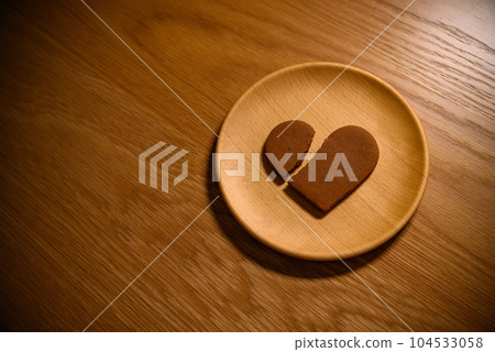 A broken heart cookie on a wooden plate Broken heart Heartbreak A broken heart cookie on a wooden plate Broken heart Heartbreak 104533058