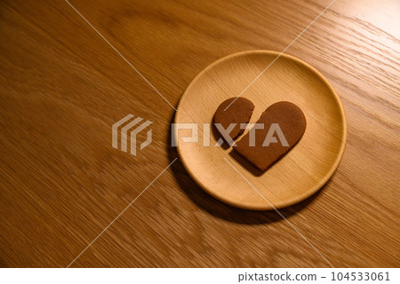 A broken heart cookie on a wooden plate, broken heart, love, heartbreak, no peripheral dimming 104533061