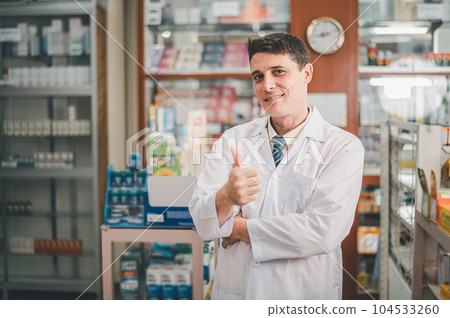 Male pharmacist posing confidently welcoming, advising patients and prescription patients in modern pharmacy. 104533260