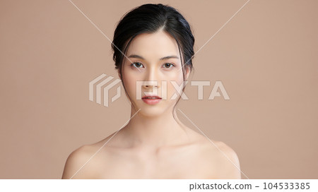Beautiful young asian woman with clean fresh skin on beige background, Face care, Facial treatment, Cosmetology, beauty and spa, Asian women portrait. Beautiful young asian woman with clean fresh skin on beige background, Face care, Facial treatment, Cosmetology, beauty and spa, Asian women portrait. 104533385