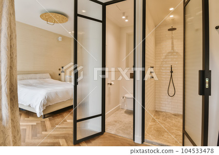 a bathroom with a bed in the corner and shower doors open to reveal a large walk - in shower area 104533478