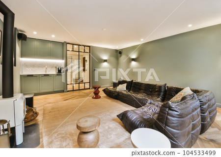 a living room with couches, coffee table, and tv on the wall in the room is very light green a living room with couches, coffee table, and tv on the wall in the room is very light green 104533499