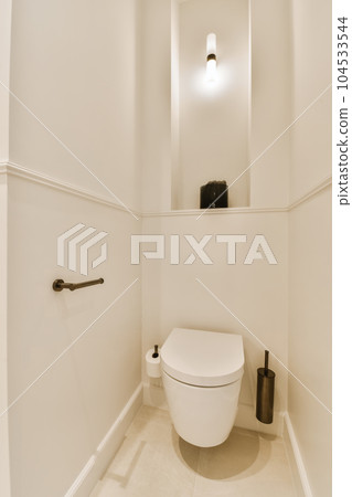 a bathroom with a toilet and mirror above the toilet is not in use, but it's very clean 104533544