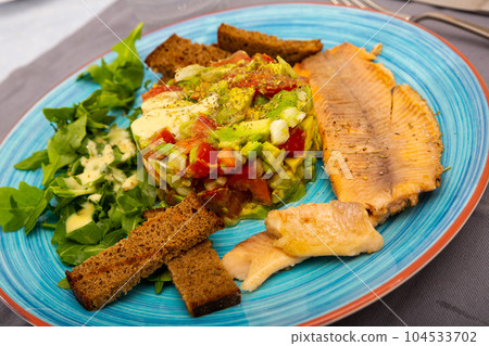 Fried trout with guacamole salad Fried trout with guacamole salad 104533702