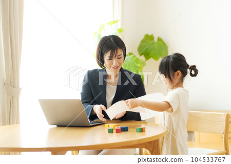 Photo of mom and girl working from home Photo of mom and girl working from home 104533767