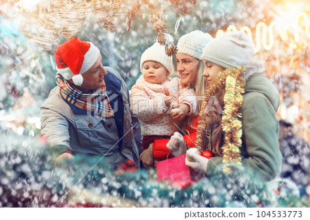 Family spending time at Christmas fair Family spending time at Christmas fair 104533773