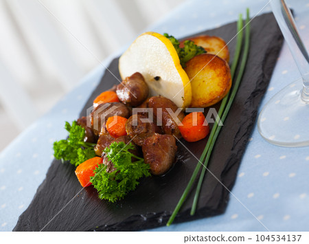 Delicious fried chicken hearts served with baked vegetables and fresh pear Delicious fried chicken hearts served with baked vegetables and fresh pear 104534137