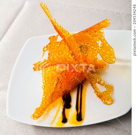 Dessert of baked pumpkin with caramel 104534248