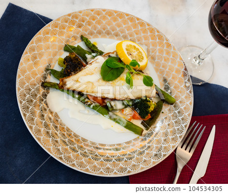Grilled fillet of dorada with lemon, vegetables and white sauce Grilled fillet of dorada with lemon, vegetables and white sauce 104534305