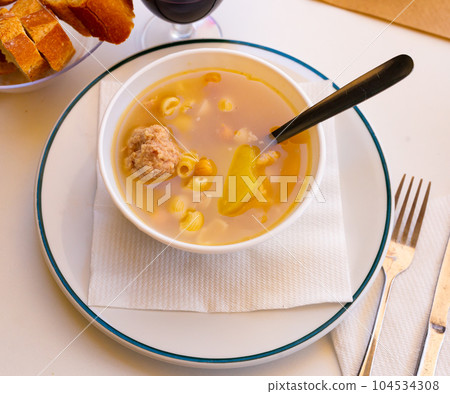 Soup with pasta, meatballs, potato slices and chickpeas Soup with pasta, meatballs, potato slices and chickpeas 104534308