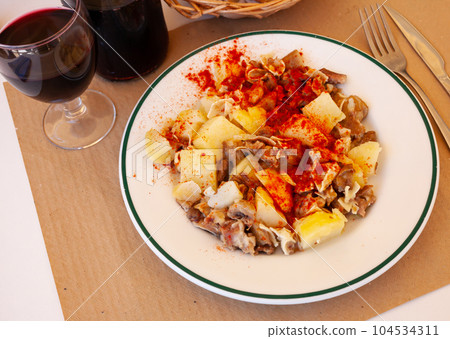Galician dish of stewed pig's ear with red pepper and potatoes Galician dish of stewed pig's ear with red pepper and potatoes 104534311