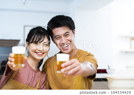 Young couple toasting with beer Young couple toasting with beer 104534429