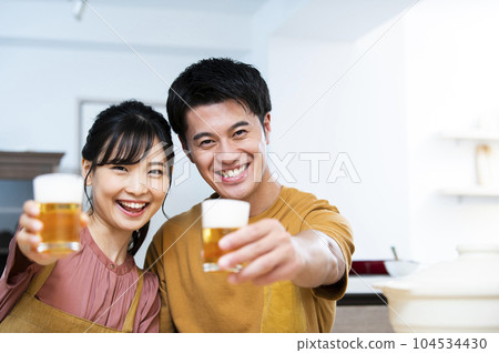 Young couple toasting with beer Young couple toasting with beer 104534430