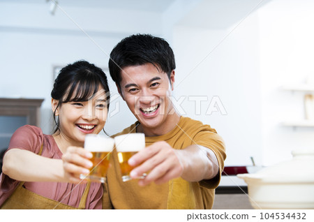 Young couple toasting with beer 104534432