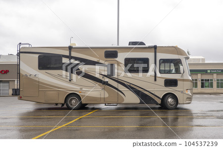 Calgary, Alberta, Canada. Jun 20, 2023. A trailer camper RV parked at a shopping centre parking lot. 104537239