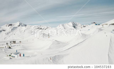 People snowboarding skiing at ski resort. Skiers, snowboarders riding snowy mountain slope. Outdoor winter sport, scineric panoramic  104537283