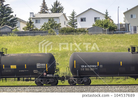 Calgary, Alberta, Canada. Jun 29, 2023. A railway train transporting flammable chemicals near a neighbourhood. Calgary, Alberta, Canada. Jun 29, 2023. A railway train transporting flammable chemicals near a neighbourhood. 104537689