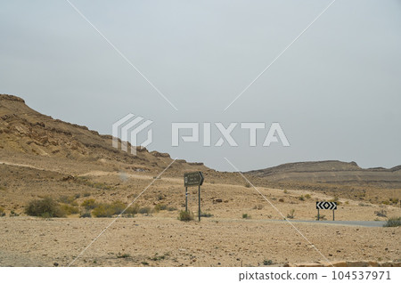 Asphalt road and Negev desert landscape in Israel. Asphalt road and Negev desert landscape in Israel. 104537971