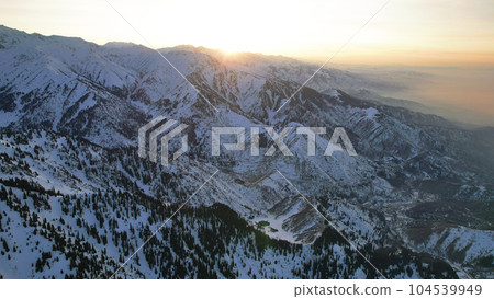 Epic red-orange sunset in high snowy mountains 104539949
