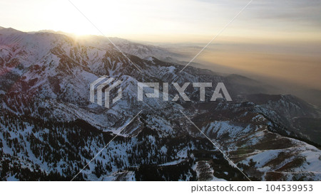 Epic red-orange sunset in high snowy mountains 104539953