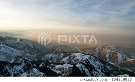 Epic red-orange sunset in high snowy mountains 104539957