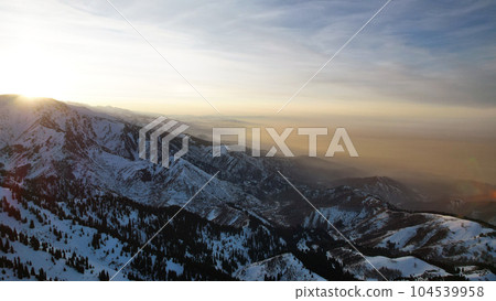 Epic red-orange sunset in high snowy mountains 104539958