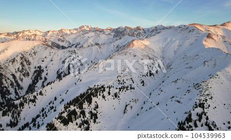 Epic red-orange sunset in high snowy mountains 104539963
