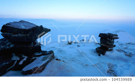 An ocean of clouds in the snowy mountains at dawn An ocean of clouds in the snowy mountains at dawn 104539989