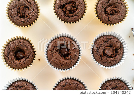 Filling s'mores cupcakes with chocolate ganache. 104540242