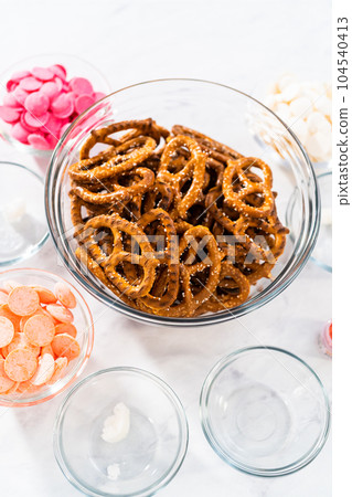 Measured ingredients in glass mixing bowls to prepare chocolate-covered pretzel twist. Measured ingredients in glass mixing bowls to prepare chocolate-covered pretzel twist. 104540413