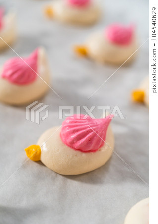 Freshly baked Easter meringue cookies in the shape of birds. 104540629